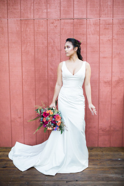 bride in front of red wall